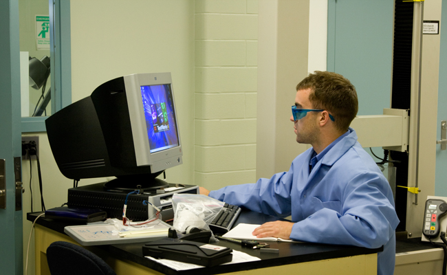 Student making parts with the press