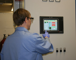 Michael Disabb-Miller operating the field assisted sintering technologies furnace